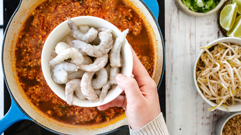 adding shrimp to soup