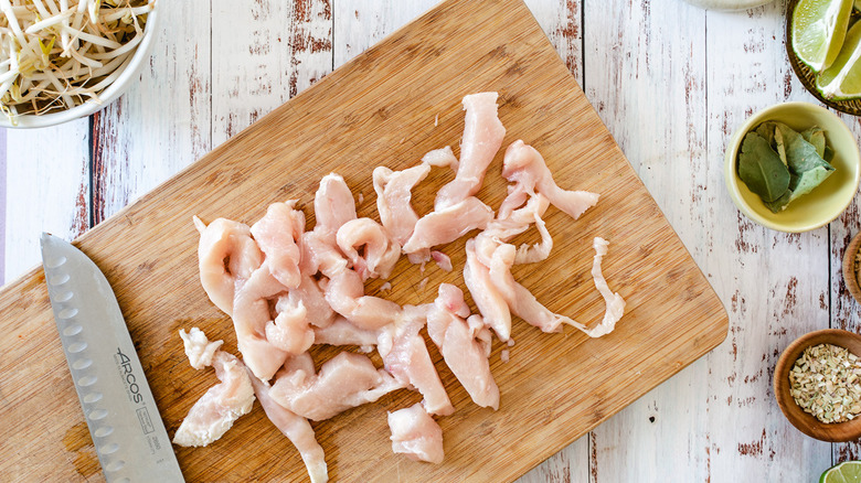 dicing chicken on cutting board