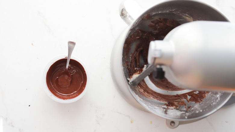 Adding melted chocolate to bowl