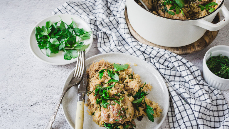 Rice and chicken on plate with pot in background