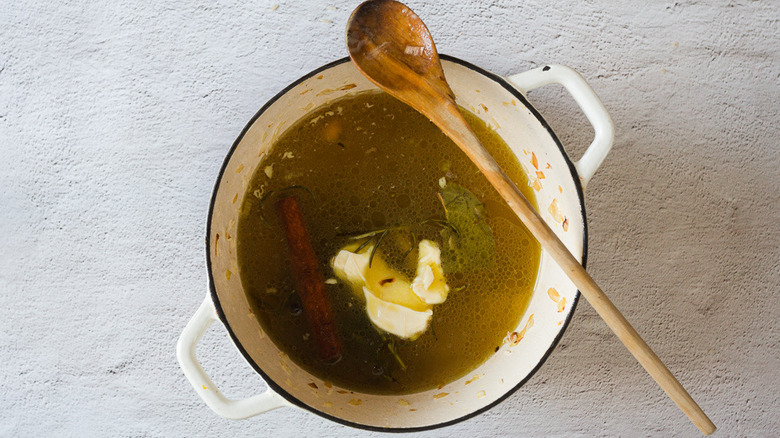 Pot with butter and wooden spoon