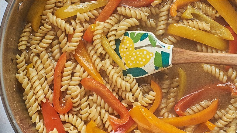 noodles and peppers in skillet