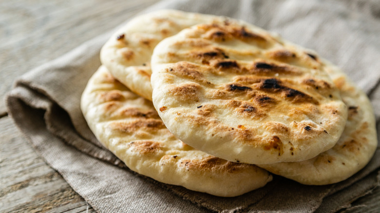 Pita breads stacked on a cloth