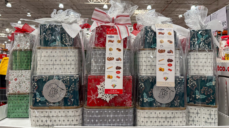 Stacks of colorful holiday tins wrapped in cellophane