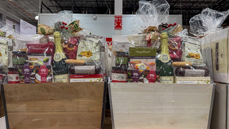 Two wooden gift baskets filled with gourmet packaged foods