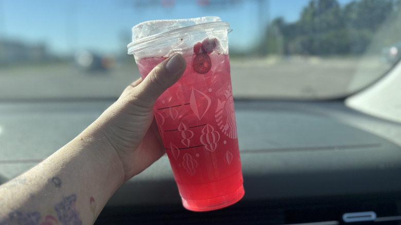 Holding up a Cran-Merry Orange Refresher Lemonade in the car