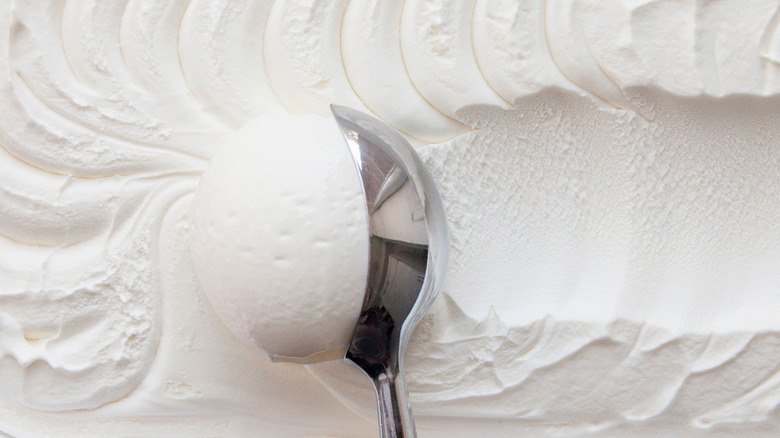 Scooper in vanilla ice cream