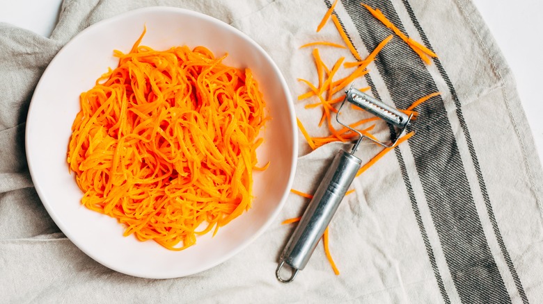 Shredded carrots and vegetable peeler 