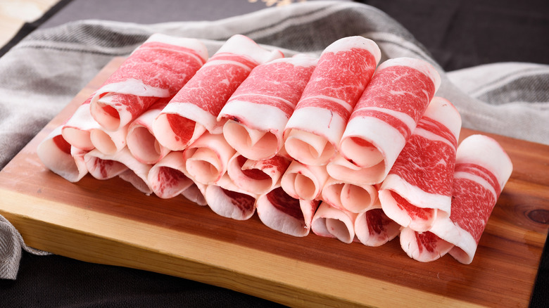 rolls of raw beef belly