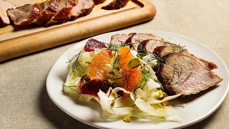 Roast pork and salad on plate