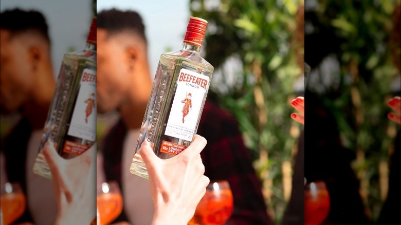 Hand holding bottle of Beefeater Gin