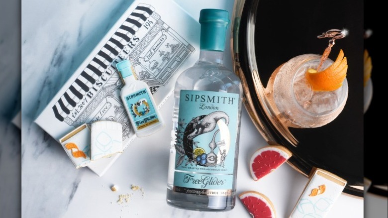 Bottle of gin, cookies, cocktail