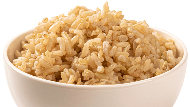 bowl of brown rice against a white background