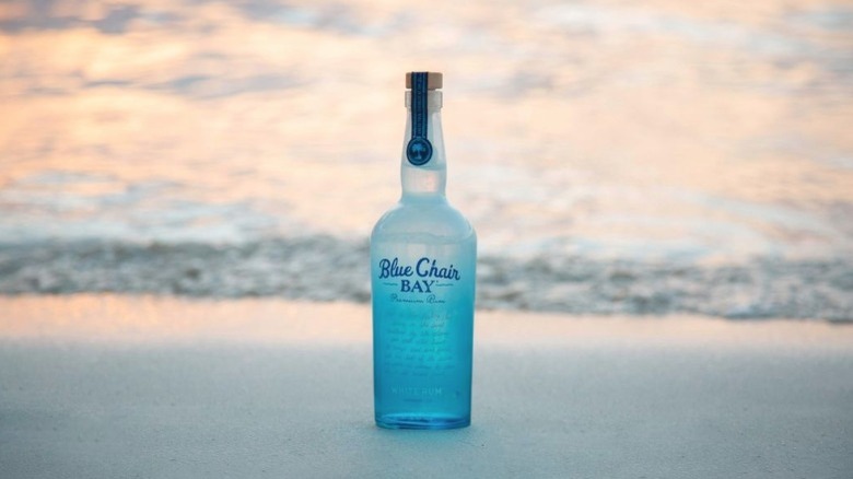 Blue rum bottle on beach