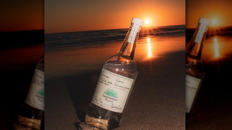 Bottle on beach at sunset