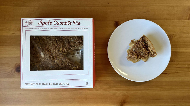 Apple crumble pie in a box, with a slice of pie on a plate