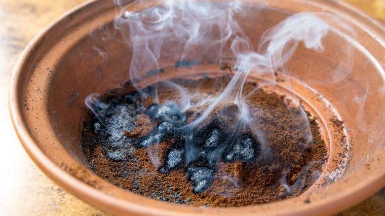 Smoking coffee grounds in bowl