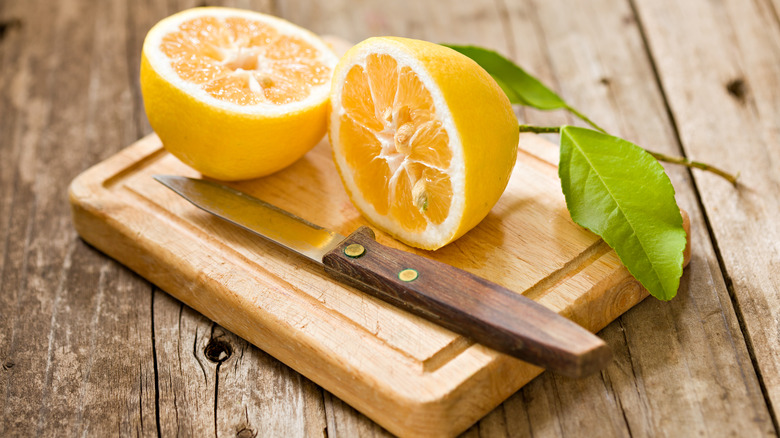 Halved lemon on cutting board