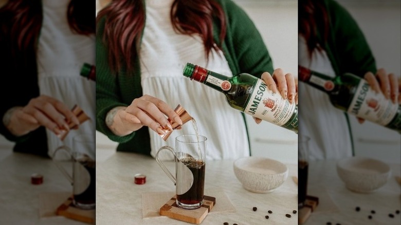 Whiskey bottle pouring into pitcher