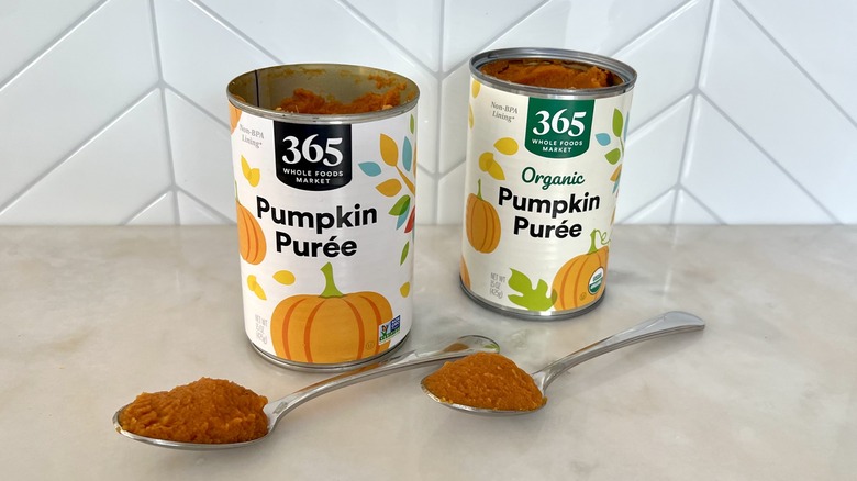 Two cans of pumpkin and spoons