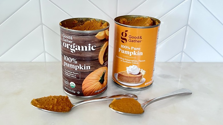 Two cans of pumpkin and spoons