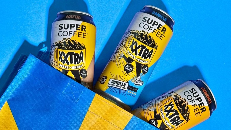 three supercoffee xxtra cans in blue bag