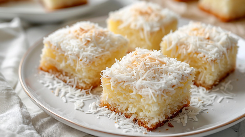 Four square slices of coconut cake