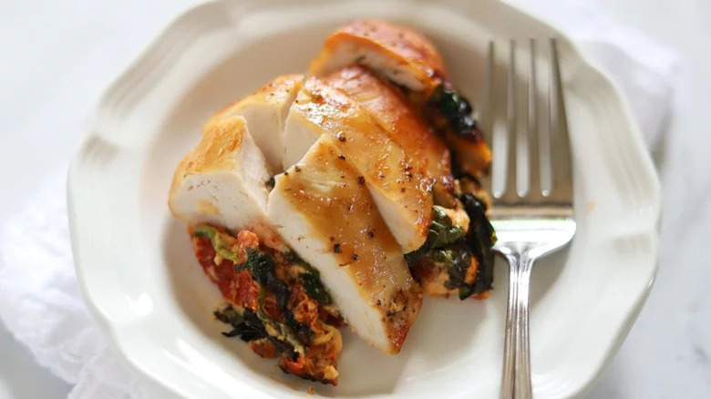 Close-up of sliced tomato-stuffed chicken