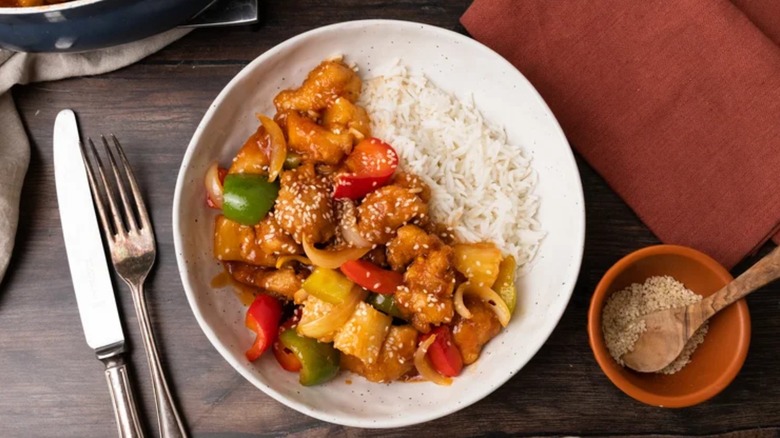 chicken and bell peppers in bowl with rice