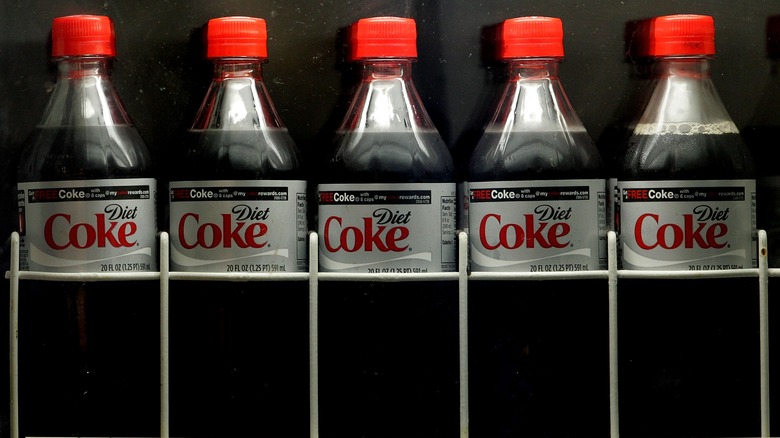 plastic bottles of Diet Coke on a shelf