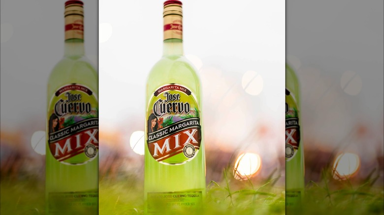 Jose Cuervo Margarita Mix bottle sitting outside in grass