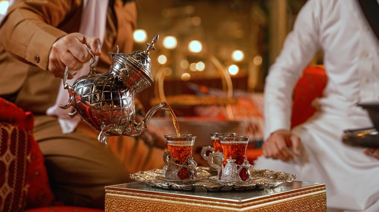 man pouring Turkish coffee