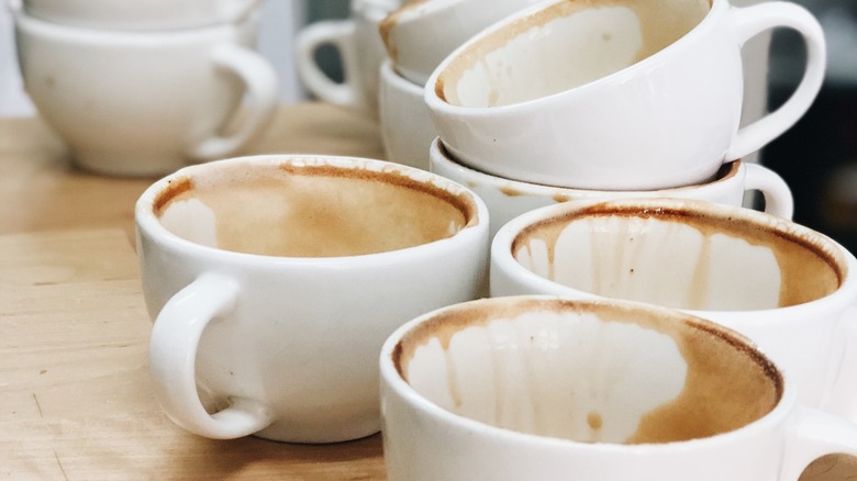 stack of dirty coffee cups