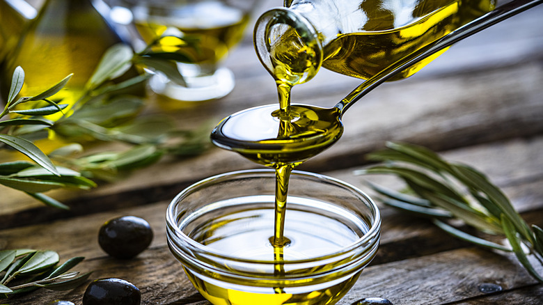 pouring olive oil into a bowl