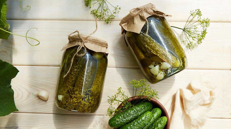 Jars of pickles on wood
