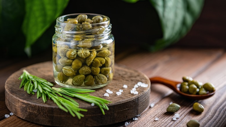 Jar of capers on wood