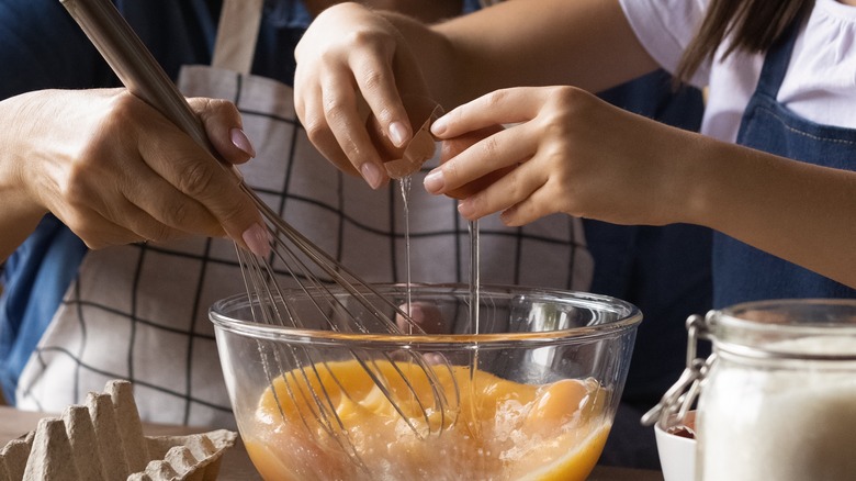 cracking egg into batter