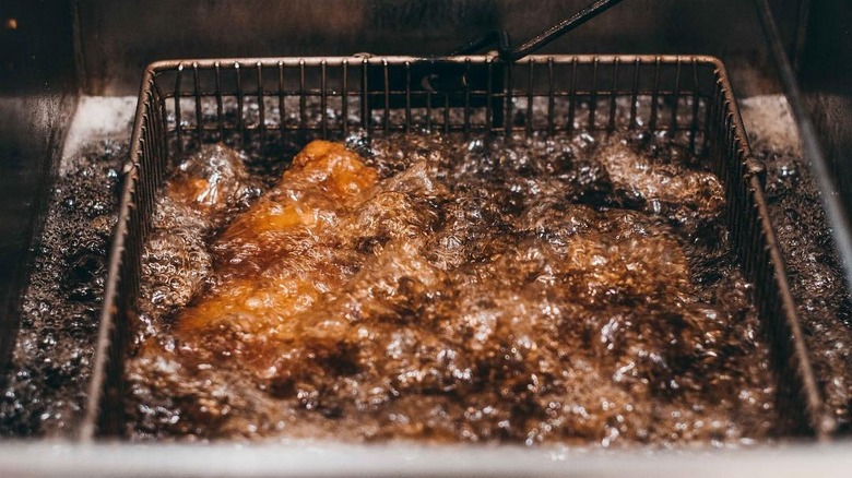 chicken deep frying in hot oil