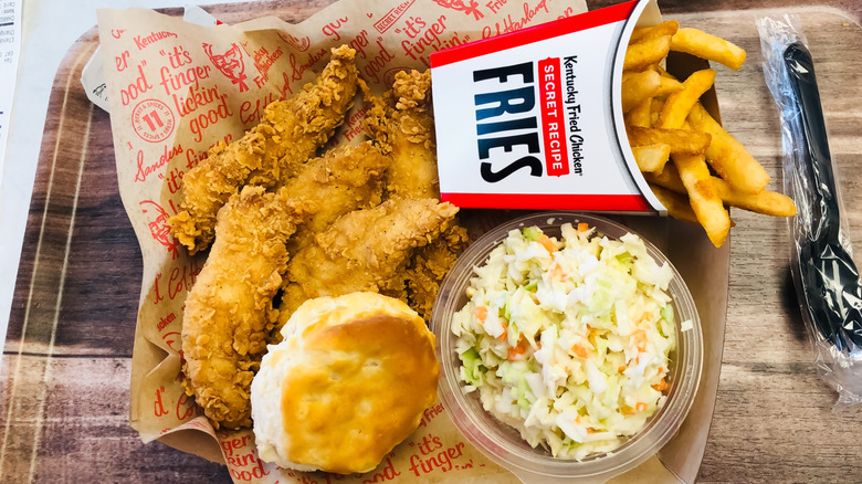 KFC fried chicken, biscuit, coleslaw, and secret recipe fries on tray