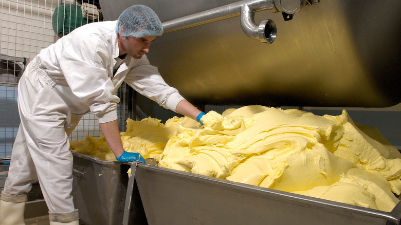 Worker and churned butter