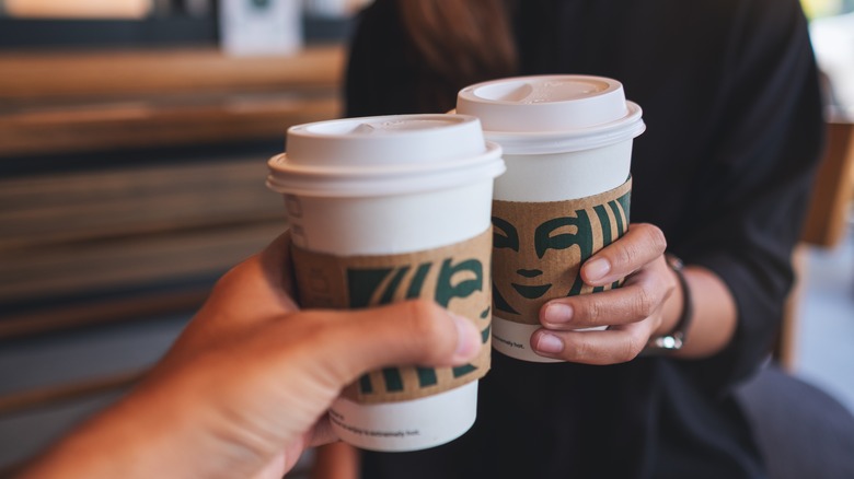 Two people drinking Starbucks