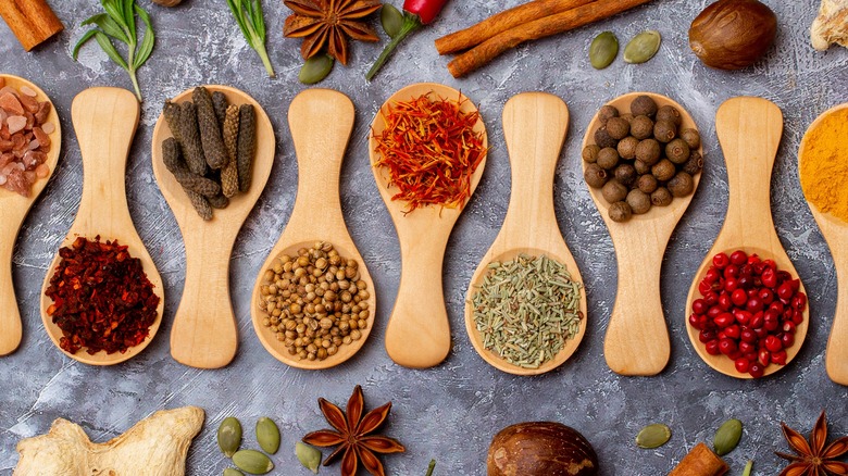 Wooden spoons with various herbs and spices laid out