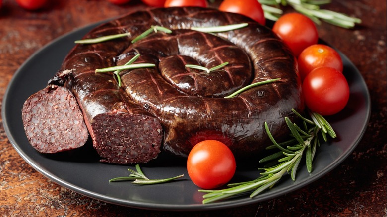 black pudding and tomatoes plated