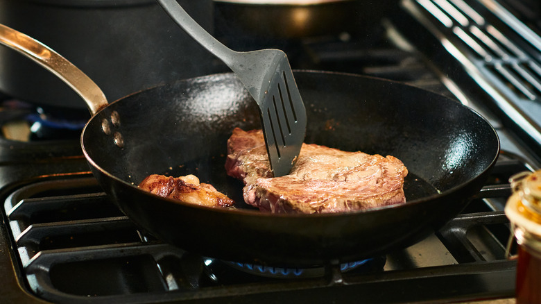 Cooking steaks in frying pan