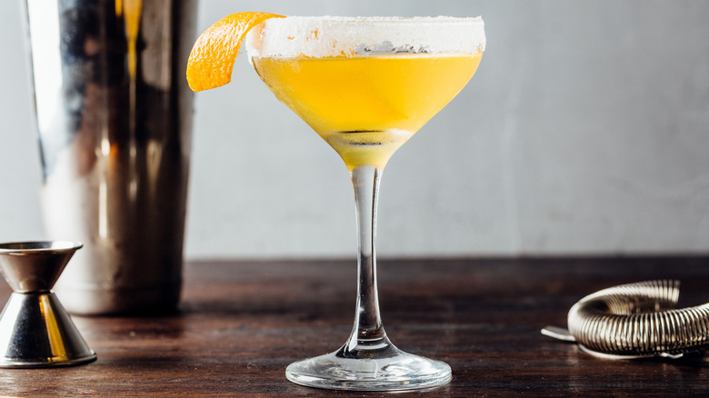 Sidecar in a stem glass, garnished with lemon peel and a frosted rim