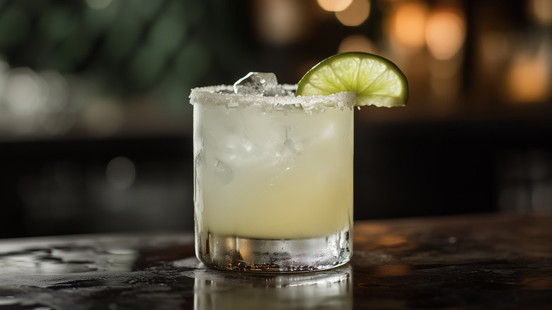 Margarita on the rocks, in a glass with a salt rim and lime wedge