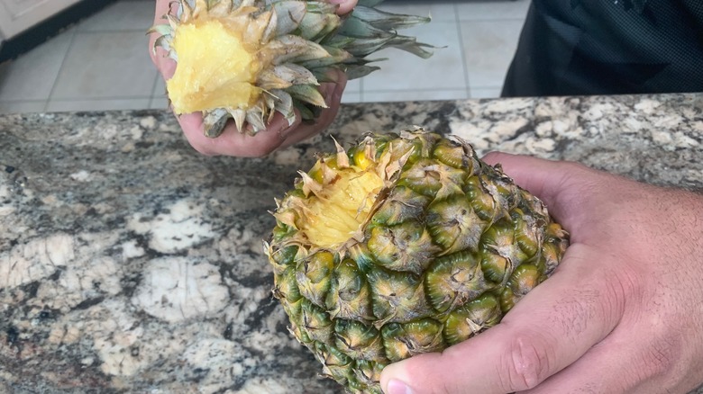 Hands twisting pineapple crown 