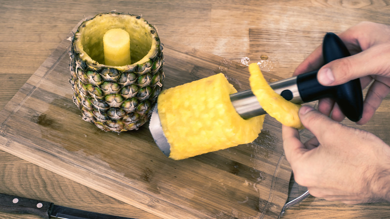 Hands holding pineapple corer 