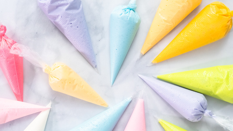 Pastry bags with various frosting colors