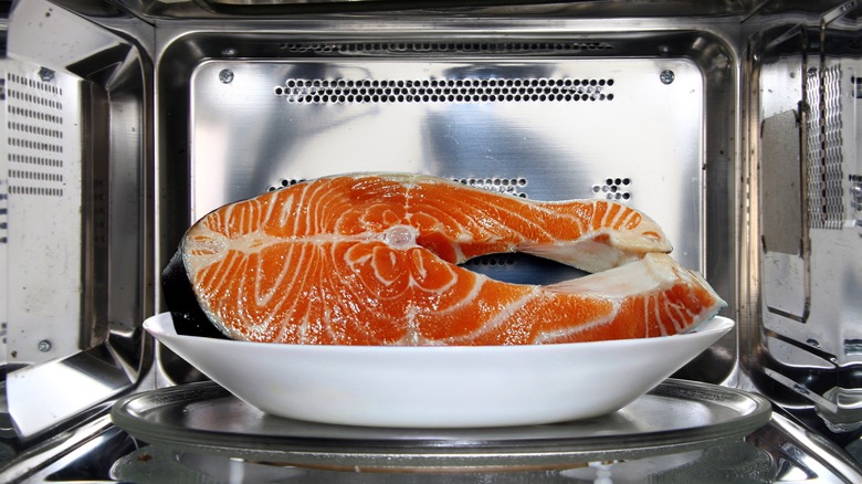 Salmon steak on plate in microwave